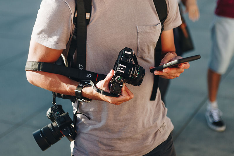 latest photography trends in 2019, male photographer looking at phone